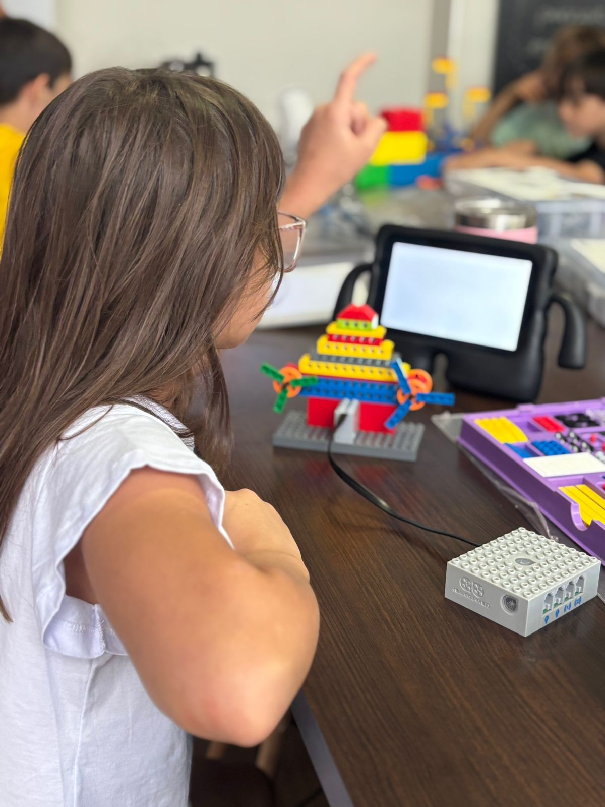 Aluna construindo robô em aula de tecnologia